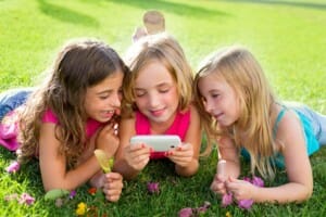 children friend girls playing internet with smartphone